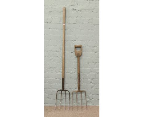 Two pieces of vintage garden equipment; a fork and a pitch fork. 
