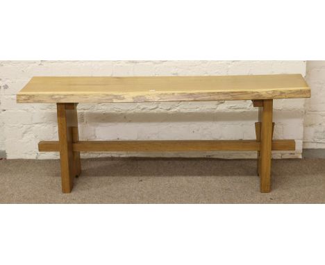 A good quality light oak trestle bench.