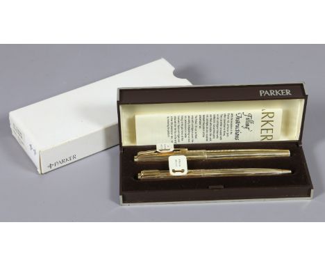 A Parker 65 custom insignia rolled gold pen set including roller ball and fountain pen.