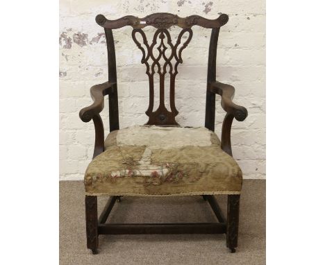 A Chippendale period mahogany library armchair. With heavily splayed back and arms with H stretcher and ornamented with blind