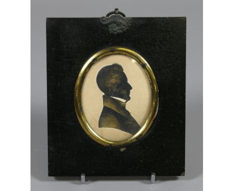A Regency silhouette portrait miniature of a gentleman heightened in gilt and in ebonized frame. 