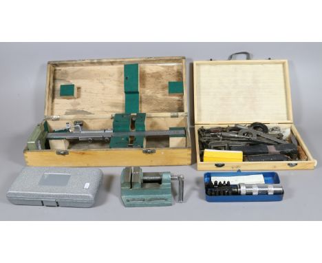 A collection of boxed engineering tools to include an impact driver, multi head screwdriver, a versagage and a workman's tabl