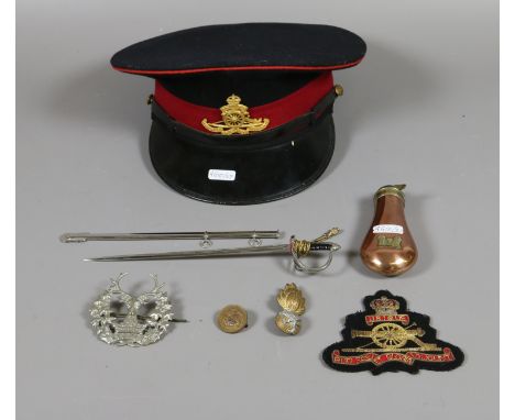 A group of military interest to include cap, badge, powder flask etc.