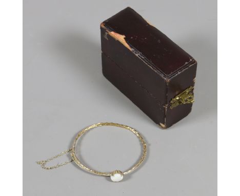 A boxed 9 carat gold rope twist bangle set with an ovoid opal applied 9ct pad mark.