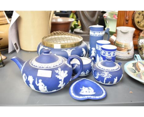 A Wedgwood Jasperware tea pot, decorated with neo-classical motifs on a blue ground, h13cm, sold together with a pair of vase