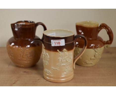 A Victorian Doultan Lambeth stoneware pitcher having hound handle and decorated with hunting scenes and Toby figures, h14cm, 