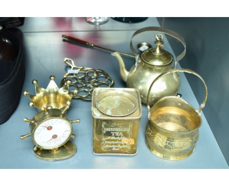 An early 20th century brass ships wheel thermometer, h12.5cm, sold together with a tea pot, candle snuff and trivet, (9)