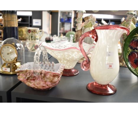 A 20th century white opalina and red glass pitcher, having shaped handle and spout, raised on a circular foot, acid-etched 'B