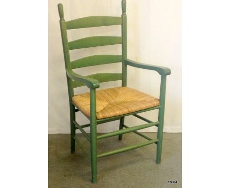 A rush seated ladder back carver chair