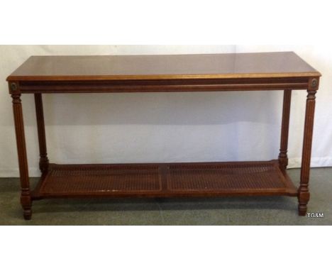 A Mahogany hall table with cane inset bottom shelf