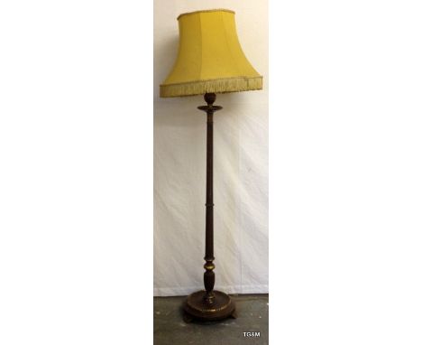 An Oak and gilded standard lamp