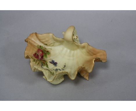 A ROYAL WORCESTER BLUSH IVORY SHELL SHAPED BOWL, with floral and butterfly decoration, raised on three periwinkles, shape No.