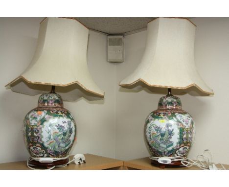 A PAIR OF CHINESE FAMILLE VERTE BULBOUS LAMP BASES AND SHADES, script, floral and insect details, on hardwood stands, height 