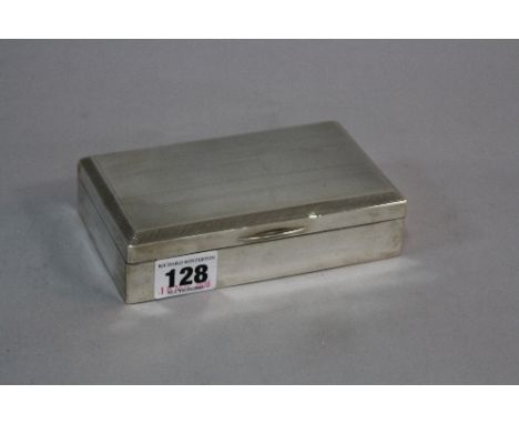 A SILVER MOUNTED RECTANGULAR BOX, having engine turned decoration and vacant cartouche to hinged lid revealing two division i