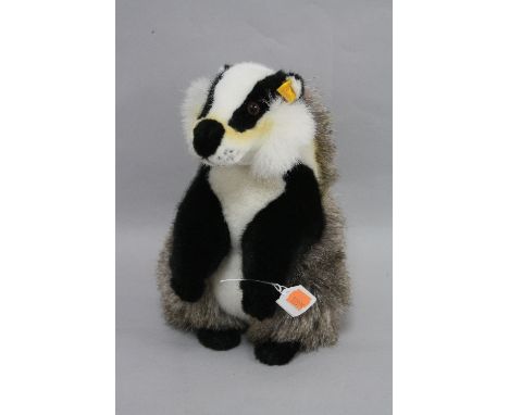A STEIFF BADGER, on hind legs, No.071270, with button in ear and orange label, height approximately 26cm