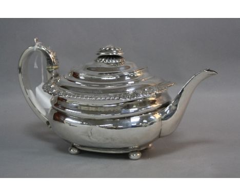 A SILVER TEAPOT, having embossed floral border and finial, set on four square ball feet, bone spacers tom handle, London 1814