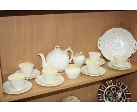 A BELLEEK TEASET, shell design with lustre glaze, comprising teapot, sugar, milk, six cups, six saucers, six tea plates and c