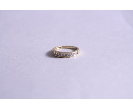 A 9CT .25CT DIAMOND HALF ETERNITY RING, ring size K