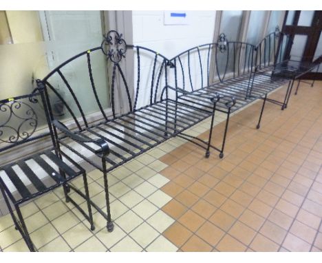 A LARGE BLACK PAINTED WROUGHT IRON BENCH, a similar bench, a smaller bench and a single chair (4)