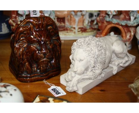A VICTORIAN TREACLE GLAZED LION SASH WINDOW STOP, and a model of a recumbent Lion (2)