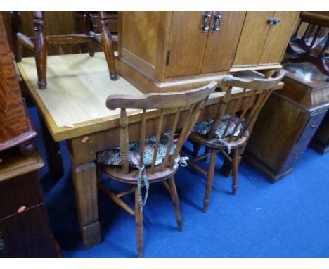 A LIGHT OAK DINING TABLE, (with later replaced top), three oak spindle back chairs and another chair (5)