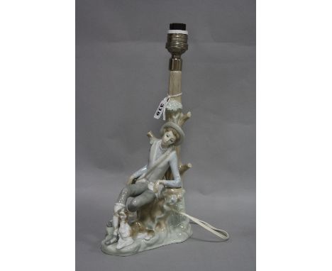 A LLADRO LAMP BASE, seated figure against tree stump with dog at feet