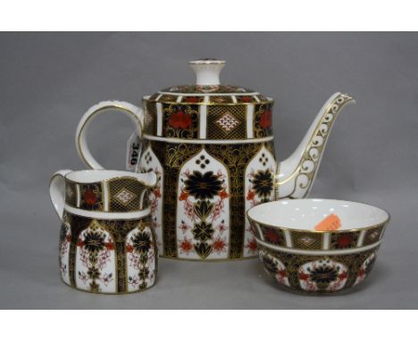 A ROYAL CROWN DERBY OLD IMARI THREE PIECE TEA SERVICE, '1128' pattern, to include teapot, open sugar and milk jug (3)