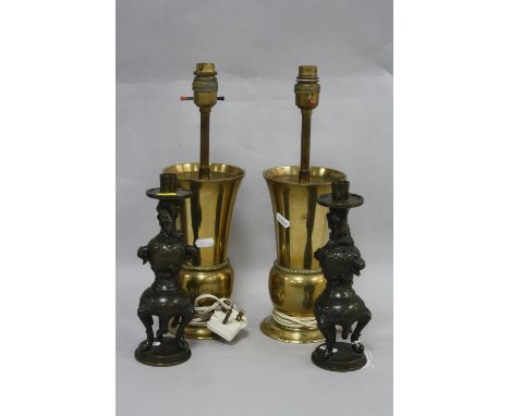 A PAIR OF CAST ORIENTAL DESIGN CANDELSTICKS, and a pair of brass lamp bases (4)