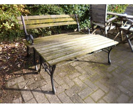 AN IRON SLATTED GARDEN BENCH, and a matching table (2)