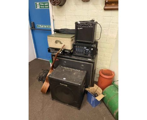 Large speaker, amplifiers, vintage turntable, guitar and music stand.