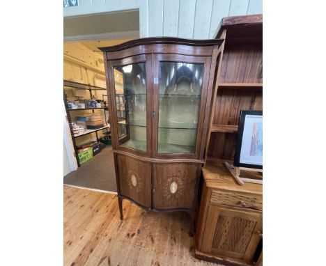 Edwardian inlaid mahogany serpentine front vitrine having two glazed panel doors above two inlaid cupboard doors, 180cm by 92