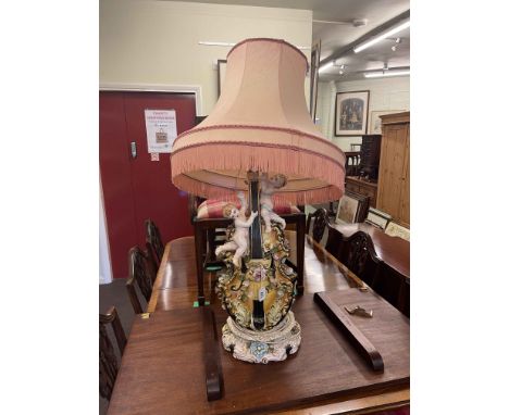 Italian Capo di Monte style violin and cherub table lamp with shade, 105cm high.