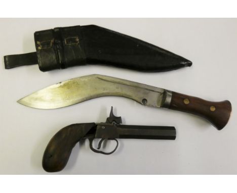 A cased kukri together with a vintage single shot pistol with wood stock handle