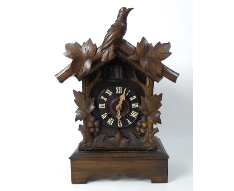 A cased wooden cuckoo mantel clock, white applied Roman numerals, chiming movement, 41cm high. 
