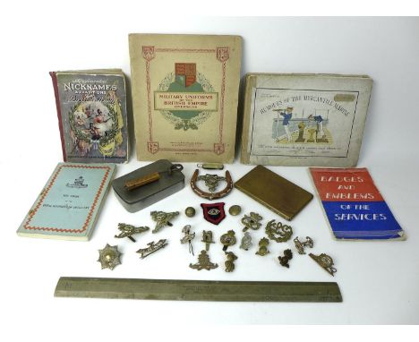 A collection of militaria including cap badges such as a Leicestershire Yeomanry cap badge, together with a WWII 1940 ruler, 