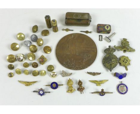 A WWI widow's penny for John Paterson, together with a group of military cap badges, buttons, pin brooches, a cast badge for 