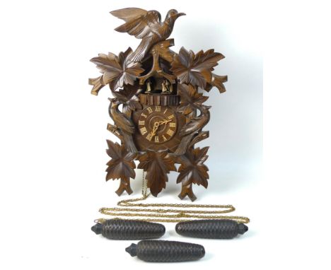 A modern carved wooden cuckoo clock, the hours marked by four dancing couples appearing, triple train movement, with three pi