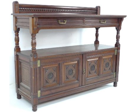 A Victorian buffet sideboard by Gillows, with upper tier shelf with two frieze drawers on column supports, below a two door c