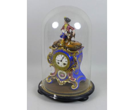 A late 19th century porcelain figural mantel clock in glass dome, with blue ground gilt highlighted Rococo case, figural surm