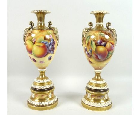 A pair of modern Royal Worcester pedestal vases, foliate clasped twin handles, decorated in a 'Hand Painted Fruit Study' one 