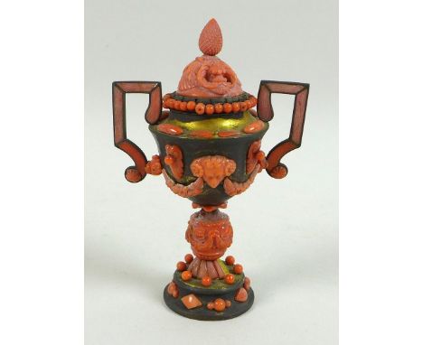 A small brass lidded urn with applied carved coral decoration, 18th/19th century, possibly Italian, with twin handles, ram's 