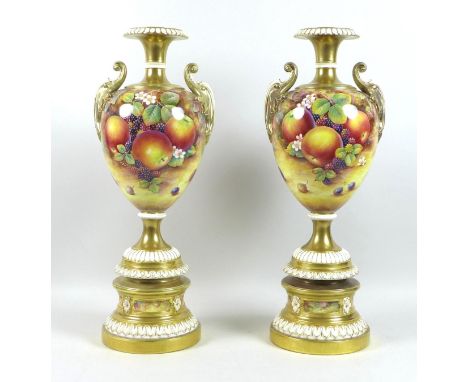 A pair of large modern Royal Worcester pedestal vases, foliate clasped twin handles, decorated with reserves of fruit 'Hand P