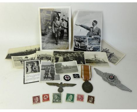 A collection of WWII and later Nazi militaria, including a Nazi 'Heim ins Reich' enamel badge, a second black enamel badge wi