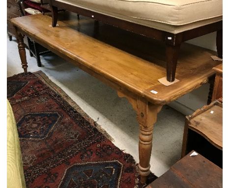 A modern pine farmhouse style kitchen table, the rectangular top with moulded edge over a plain frieze on turned and ring tap