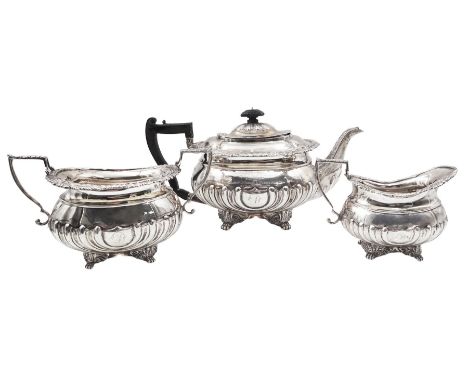 Edwardian three piece silver tea service, comprising teapot with ebonised handle and finial, twin handled open sucrier, and m