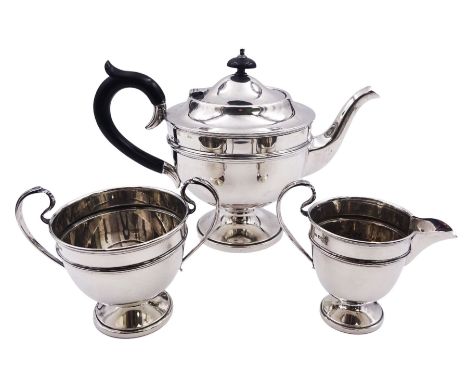 1930's silver three piece tea service, comprising teapot with ebonised handle and finial, twin handled sucrier, and milk jug,