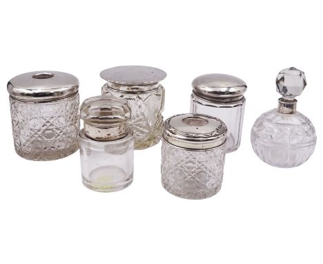 Group of silver mounted glass dressing table jars and bottles, to include an early 20th century hair tidy jar with octagonal 