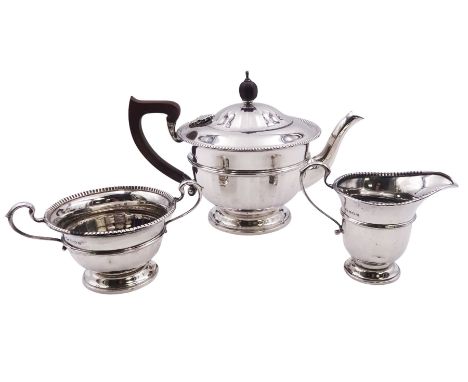 1930's silver three piece tea service, comprising teapot with wooden handle and finial, and engraved dedication to body, twin