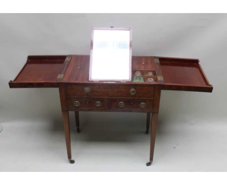 A 19TH CENTURY MAHOGANY DRESSING TABLE the top having book opening flaps, revealing an interior, fitted with glass bottles, w