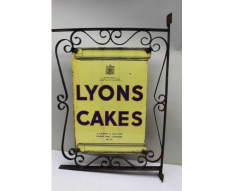 A 'LYONS CAKES' DOUBLE SIDED ENAMEL SIGN set in wrought metal frame for securing to a wall, 72cm x 57cm overall 